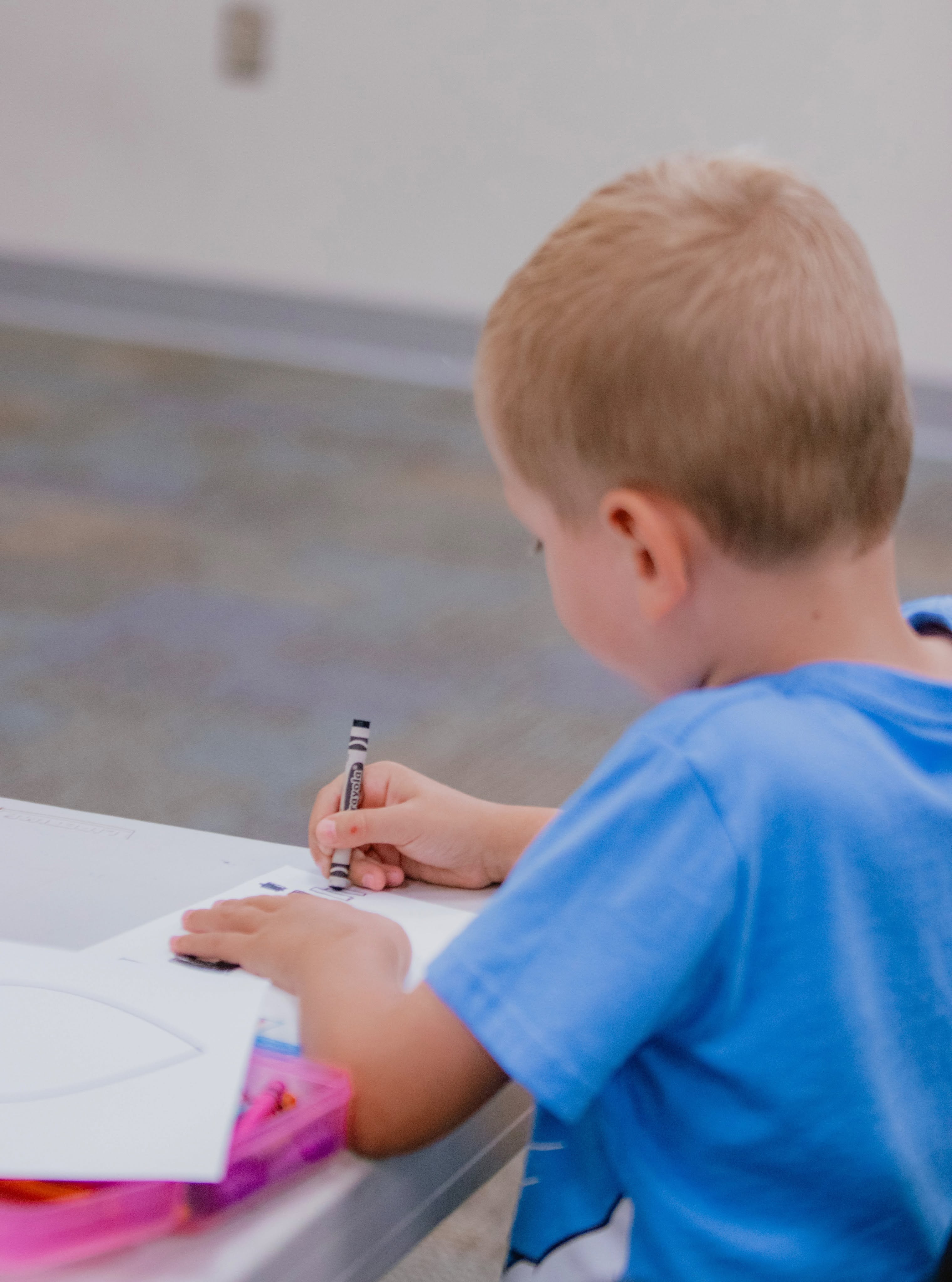 A child coloring at Kid Life